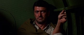 Movie still from “Tobruk” (1967), directed by Arthur Hiller – A person holding a knife in his hand; Close Up shot, Low angle