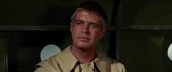 Movie still from “Tobruk” (1967), directed by Arthur Hiller – A person wearing a shirt and a tie; Close Up shot, Low angle