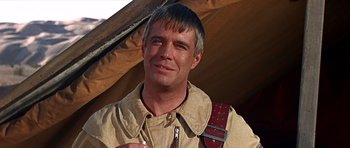 Movie still from “Tobruk” (1967), directed by Arthur Hiller – A person wearing a jacket; Close Up shot, Over the shoulder angle