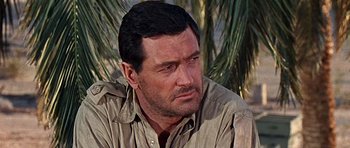 Movie still from “Tobruk” (1967), directed by Arthur Hiller – A person wearing a brown shirt; Close Up shot, Over the shoulder angle