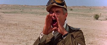 Movie still from “Tobruk” (1967), directed by Arthur Hiller – A man in a military uniform is yelling; Close Up shot, Low angle
