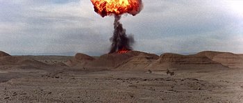 Movie still from “Tobruk” (1967), directed by Arthur Hiller – An explosion in the sky with a cloud of smoke coming out of it; Extreme Wide shot, Low angle