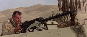Movie still from “Tobruk” (1967), directed by Arthur Hiller – A machine gun sitting on top of an armored vehicle; Medium shot, Low angle