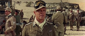 Movie still from “Tobruk” (1967), directed by Arthur Hiller – A man in a military uniform and a hat; Close Up shot, Low angle
