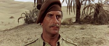 Movie still from “Tobruk” (1967), directed by Arthur Hiller – A person wearing a hat; Close Up shot, Low angle