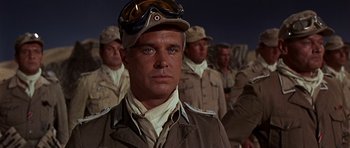 Movie still from “Tobruk” (1967), directed by Arthur Hiller – A group of men standing next to each other in uniforms; Close Up shot, Low angle