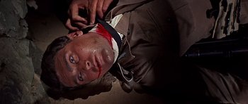 Movie still from “Tobruk” (1967), directed by Arthur Hiller – A man with a bandage on his head and face; Close Up shot, Overhead angle