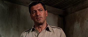 Movie still from “Tobruk” (1967), directed by Arthur Hiller – A person wearing a shirt; Close Up shot, Low angle