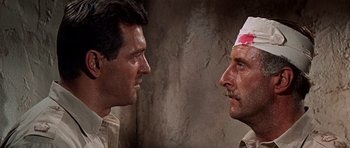 Movie still from “Tobruk” (1967), directed by Arthur Hiller – Two men face each other in a fight scene; Close Up shot, Over the shoulder angle