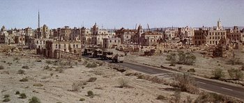 Movie still from “Tobruk” (1967), directed by Arthur Hiller – An old town is shown in the middle of the desert; Extreme Wide shot, High angle