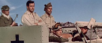 Movie still from “Tobruk” (1967), directed by Arthur Hiller – A group of men sitting on top of a truck; Medium shot, High angle