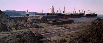 Movie still from “Tobruk” (1967), directed by Arthur Hiller – An old truck is parked in the middle of the desert; Extreme Wide shot, Low angle