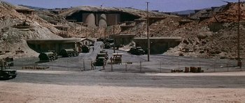 Movie still from “Tobruk” (1967), directed by Arthur Hiller – An intersection in the middle of a dirt road; Extreme Wide shot, High angle