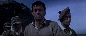 Movie still from “Tobruk” (1967), directed by Arthur Hiller – A person wearing a sweater; Close Up shot, Low angle