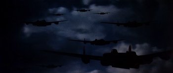 Movie still from “Tobruk” (1967), directed by Arthur Hiller – A group of planes flying in the sky at night; Extreme Wide shot, Low angle