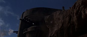 Movie still from “Tobruk” (1967), directed by Arthur Hiller – A man standing on top of a mountain at night; Extreme Wide shot, Low angle