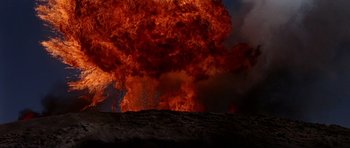 Movie still from “Tobruk” (1967), directed by Arthur Hiller – An explosion is seen in the background of this picture; Extreme Wide shot, Low angle