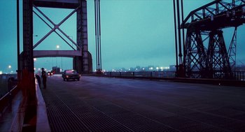 Movie still from “Happy Together” (1997), directed by Kar-Wai Wong – A car is driving on a bridge at night; Extreme Wide shot, High angle