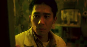 Movie still from “Happy Together” (1997), directed by Kar-Wai Wong – A person wearing a jacket; Close Up shot, Low angle