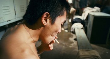 Movie still from “Happy Together” (1997), directed by Kar-Wai Wong – A man with a cigarette in his mouth; Close Up shot, Over the shoulder angle