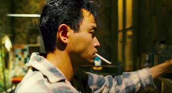 Movie still from “Happy Together” (1997), directed by Kar-Wai Wong – A man with a cigarette in his mouth; Close Up shot, Low angle