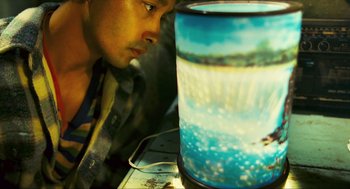 Movie still from “Happy Together” (1997), directed by Kar-Wai Wong – A man is looking at a picture of the ocean; Close Up shot, High angle