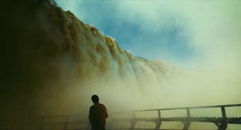 Movie still from “Happy Together” (1997), directed by Kar-Wai Wong – A man standing in front of a large waterfall; Extreme Wide shot, Low angle