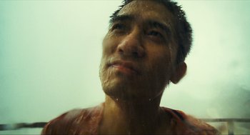 Movie still from “Happy Together” (1997), directed by Kar-Wai Wong – A person with a wet shirt on; Extreme Close Up shot, Low angle