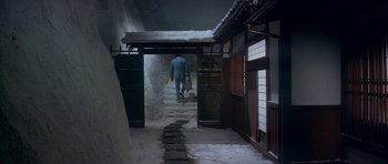 A man walking down a snow covered staircase