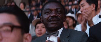 A person wearing a suit and a bow tie