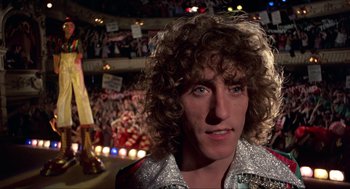 Movie still from “Tommy” (1975), directed by Ken Russell – A person wearing a wig; Close Up shot, Low angle