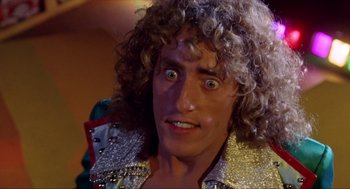 Movie still from “Tommy” (1975), directed by Ken Russell – A person wearing a costume; Close Up shot, Low angle