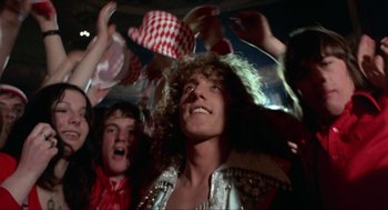 Movie still from “Tommy” (1975), directed by Ken Russell – A group of young people dancing at a party; Medium shot, Low angle