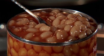 Movie still from “Tommy” (1975), directed by Ken Russell – A bowl of beans with a spoon; Extreme Close Up shot, High angle