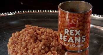 Movie still from “Tommy” (1975), directed by Ken Russell – A can of baked beans next to a pile of baked beans; Extreme Close Up shot, Overhead angle