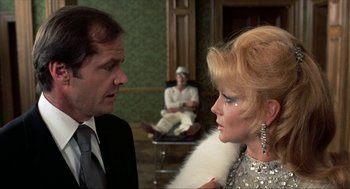 Movie still from “Tommy” (1975), directed by Ken Russell – A man and a woman are talking to each other in a room; Close Up shot, Over the shoulder angle