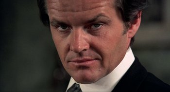 Movie still from “Tommy” (1975), directed by Ken Russell – A person wearing a suit and tie; Close Up shot, Low angle