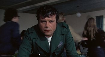 Movie still from “Tommy” (1975), directed by Ken Russell – A person wearing a green jacket; Close Up shot, Low angle