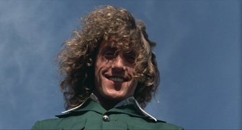 Movie still from “Tommy” (1975), directed by Ken Russell – A person with long hair; Close Up shot, Low angle