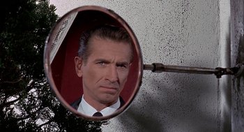 Movie still from “Topaz” (1969), directed by Alfred Hitchcock – A reflection of a man in a mirror; Extreme Close Up shot, Low angle