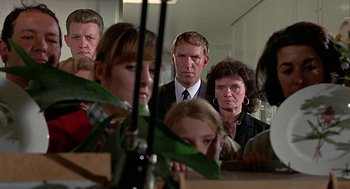 Movie still from “Topaz” (1969), directed by Alfred Hitchcock – A group of people standing in front of a mirror; Medium shot, Over the shoulder angle