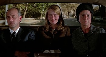 Movie still from “Topaz” (1969), directed by Alfred Hitchcock – A woman sitting in the back seat of a car; Medium shot, High angle