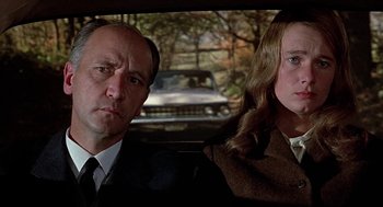 Movie still from “Topaz” (1969), directed by Alfred Hitchcock – A man and a woman sitting in the back of a car; Close Up shot, Over the shoulder angle