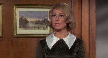 Movie still from “Topaz” (1969), directed by Alfred Hitchcock – A woman with blonde hair wearing a black and white dress; Close Up shot, Over the shoulder angle