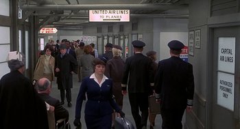 Movie still from “Topaz” (1969), directed by Alfred Hitchcock – A group of people walking through an airport terminal; Wide shot, High angle