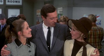 Movie still from “Topaz” (1969), directed by Alfred Hitchcock – Two women and a man standing next to each other; Medium shot, Over the shoulder angle