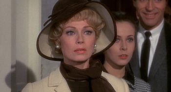 Movie still from “Topaz” (1969), directed by Alfred Hitchcock – A woman wearing a hat and a jacket; Close Up shot, Over the shoulder angle