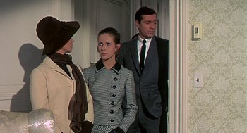 Movie still from “Topaz” (1969), directed by Alfred Hitchcock – A group of people standing next to each other in a room; Medium shot, Over the shoulder angle