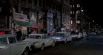Movie still from “Topaz” (1969), directed by Alfred Hitchcock – A bunch of cars parked on the side of the street; Extreme Wide shot, High angle