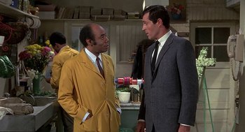 Movie still from “Topaz” (1969), directed by Alfred Hitchcock – Two men standing next to each other in a room; Medium shot, Over the shoulder angle
